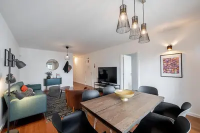 a living room with a wooden table and chairs at Barreiros II by An Island Apart in Funchal