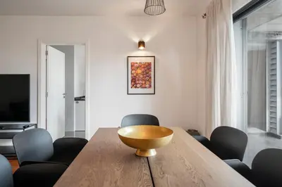 a dining room with a wooden table and chairs at Barreiros II by An Island Apart in Funchal