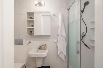 a white bathroom with a sink and a shower at Barreiros II by An Island Apart in Funchal