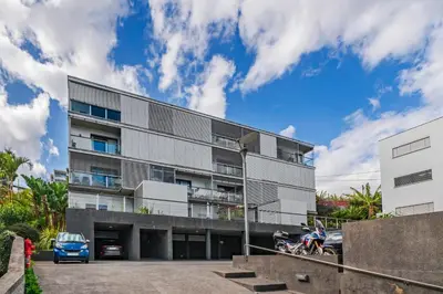 an apartment building with a car parked in front of it at Barreiros II by An Island Apart in Funchal