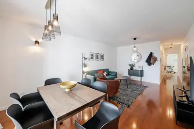 a dining room and living room with a table and chairs at Barreiros II by An Island Apart in Funchal