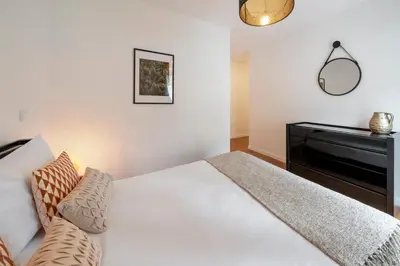 a bedroom with a white bed and a piano at Barreiros II by An Island Apart in Funchal