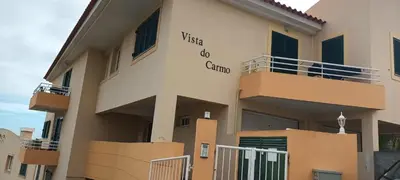a building with a sign on the side of it at Cantinho da Té in Câmara de Lobos
