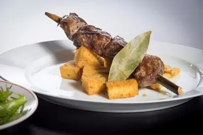 a white plate with food on a table at Cantinho da Té in Câmara de Lobos