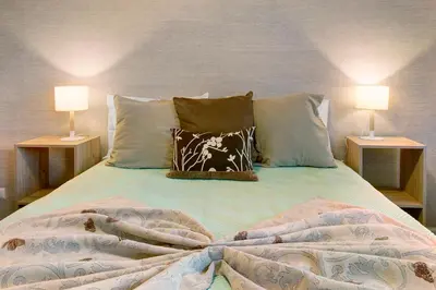 a bedroom with a bed with two lamps on both sides at Seaside Escape in Funchal