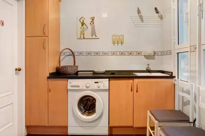 a laundry room with a washing machine and a sink at Seaside Escape in Funchal