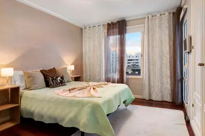 a bedroom with a bed and a large window at Seaside Escape in Funchal