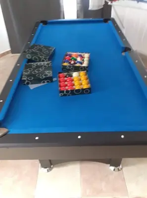 a blue pool table with four balls on it at Sunnyside Villa in Arco da Calheta