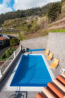 a swimming pool on top of a house at Sunnyside Villa in Arco da Calheta