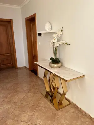 a table with a vase of flowers on it at Sunnyside Villa in Arco da Calheta