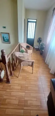 a room with a staircase with a table and chairs at Chalé Seixal - Sea View in Seixal