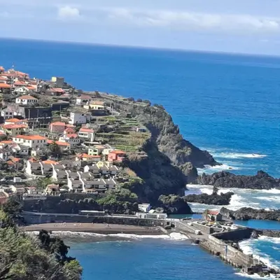 a town on a hill next to the ocean at Chalé Seixal - Sea View in Seixal