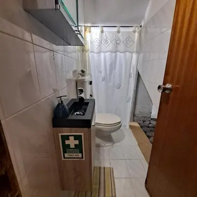 a small bathroom with a toilet and a sink at Chalé Seixal - Sea View in Seixal
