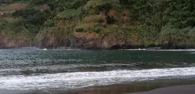 a body of water with a rocky shoreline at Chalé Seixal - Sea View in Seixal