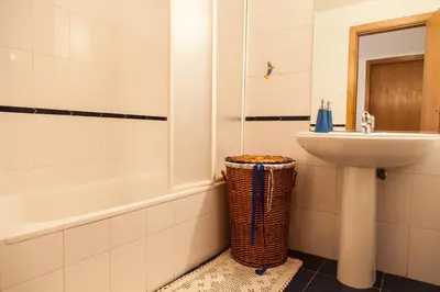 a bathroom with a sink and a toilet and a tub at Casa Da Atalaia in Caniço