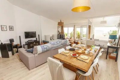 a living room with a table and a couch at C18 - Church Square Apartment in Praia da Luz in Luz