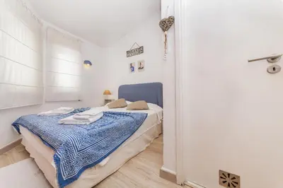 a bedroom with a bed in a room with a door at C18 - Church Square Apartment in Praia da Luz in Luz