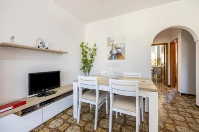 a living room with a table and a tv at Villas Brites nº4 in Burgau