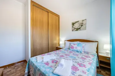 a bedroom with a bed with two towels on it at Villas Brites nº4 in Burgau