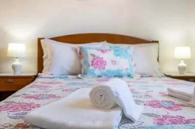 a bed with a towel on it with two lamps at Villas Brites nº4 in Burgau