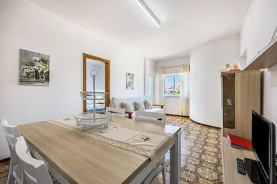 a dining room with a table and chairs and a window at Villas Brites nº4 in Burgau