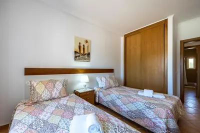 a towel sitting on top of a bed at Casa Bege T1 in Burgau