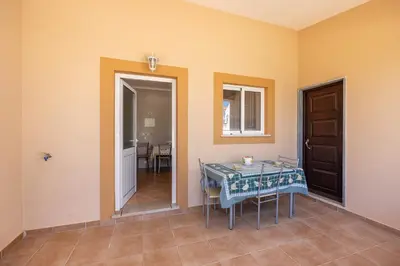 a house with a white fence on the side of the street at Casa Bege T1 in Burgau
