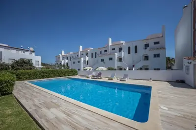a swimming pool in the backyard of a villa at Casa Bege T1 in Burgau