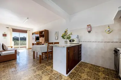 a kitchen and dining room with a table and a dining room at Villas Brites nº5 in Burgau