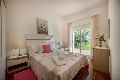 a bedroom with a bed with a tray on it at Villas Brites nº2 in Burgau