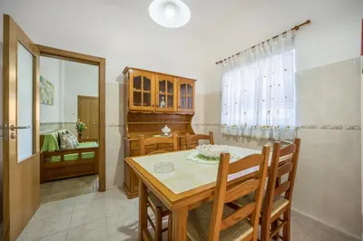a dining room with a table and a sink at Villas Brites nº2 in Burgau