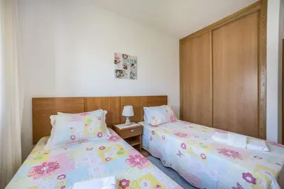 two beds sitting next to each other in a bedroom at Villas Brites nº3 in Burgau