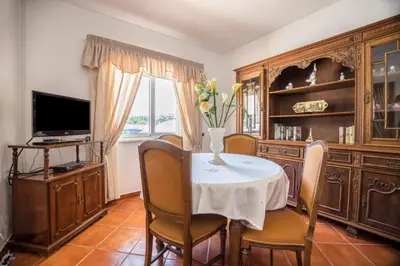 a living room with a table and a couch at Casa Fernandes in Burgau