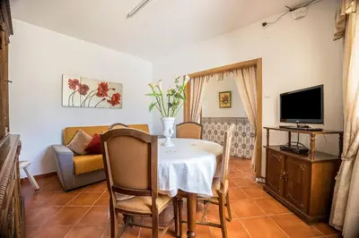 a living room with a couch and a table at Casa Fernandes in Burgau