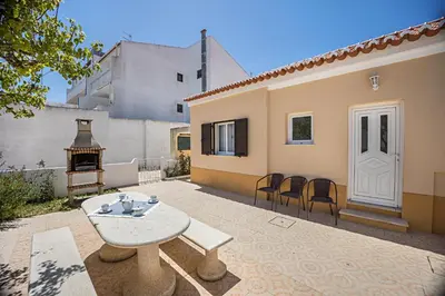 a swimming pool with a dolphin in the water at Casa Fernandes in Burgau