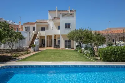 a villa with a swimming pool in front of a house at Villas Brites nº1 in Burgau