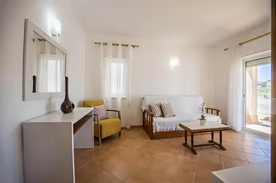 a living room with a couch and a table at Casa Bege T2 in Burgau