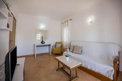 a living room with a couch and a table at Casa Bege T2 in Burgau