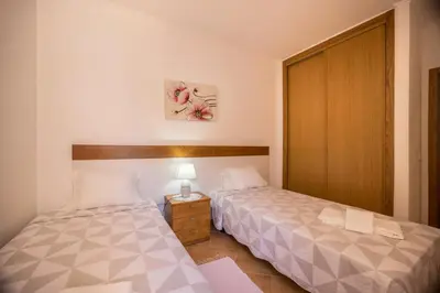 a bathroom with a sink and a toilet and a tub at Casa Bege T2 in Burgau