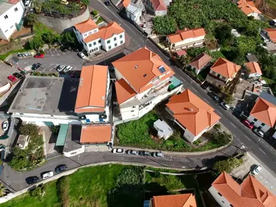 an overhead view of a suburb with houses and a street at Mountain View Star in Estreito da Calheta