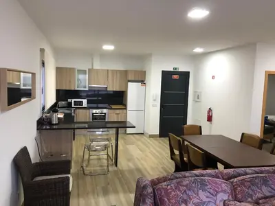 a kitchen and dining room with a table and chairs at Calheta Ocean View Family Apartment - Air Condition in Estreito da Calheta