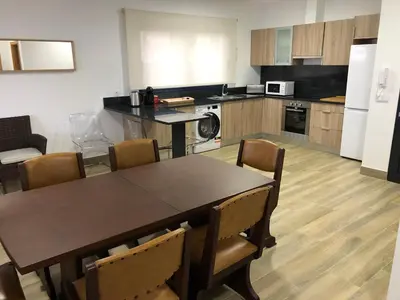 a kitchen with a table and chairs in a room at Calheta Ocean View Family Apartment - Air Condition in Estreito da Calheta