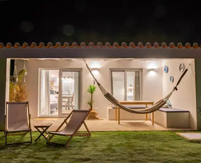 a room with a hammock and two chairs at Ao Sabor do Vento (+12 ) in Aljezur
