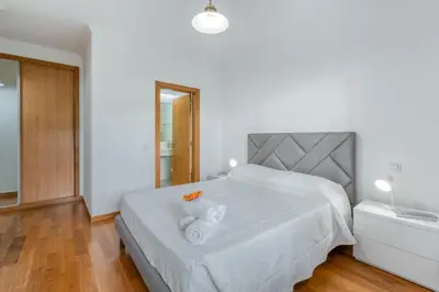 a bedroom with a bed with two towels on it at Jardim do Jasmineiro by Amazing Madeira in Funchal