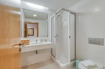 a bathroom with a shower and a sink at Jardim do Jasmineiro by Amazing Madeira in Funchal
