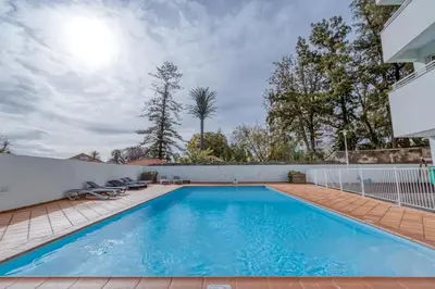 a swimming pool with blue water in a yard at Jardim do Jasmineiro by Amazing Madeira in Funchal
