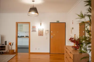 a living room with a door and a kitchen at Jardim do Jasmineiro by Amazing Madeira in Funchal