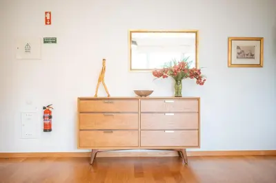 a dresser with a vase on it in a room at Jardim do Jasmineiro by Amazing Madeira in Funchal