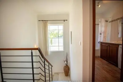 a hallway with a staircase and a window in a house at Villa Carraig in Luz