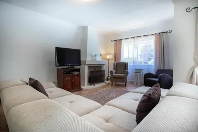 a living room with a couch and a television at Villa Carraig in Luz